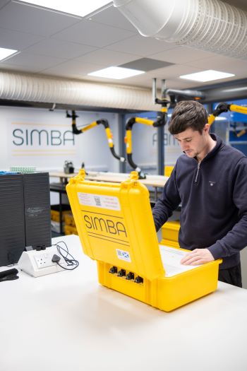 Engineer working on a SIMBA unit in the lab Engineer working on a SIMBA unit in the lab